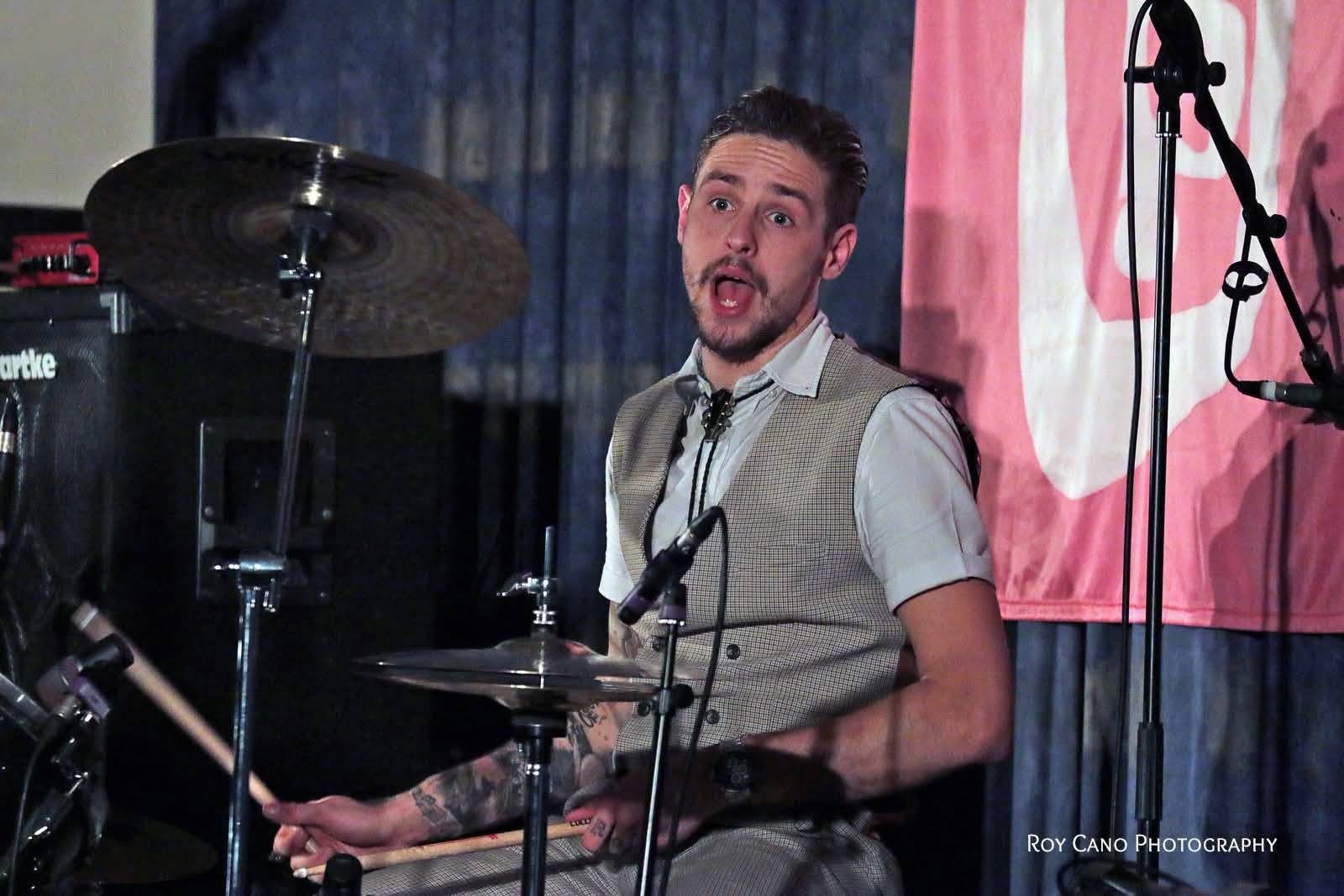 The band at a gig with coloured lighting