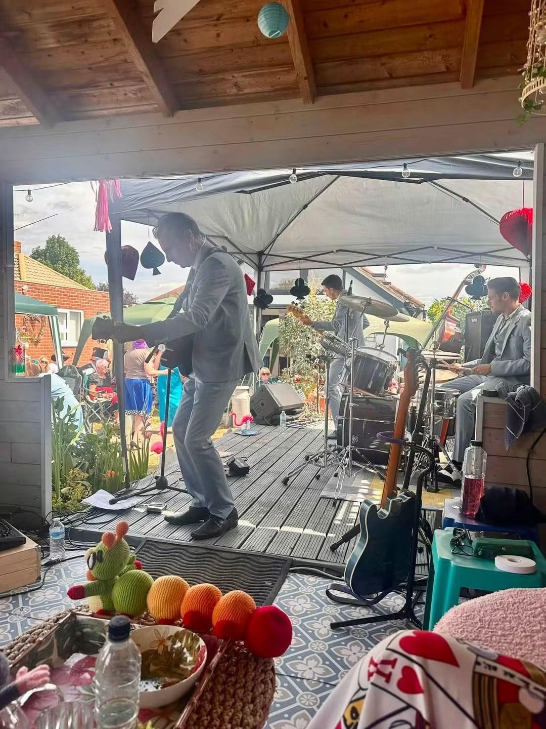 Full band performing at an outdoor garden party