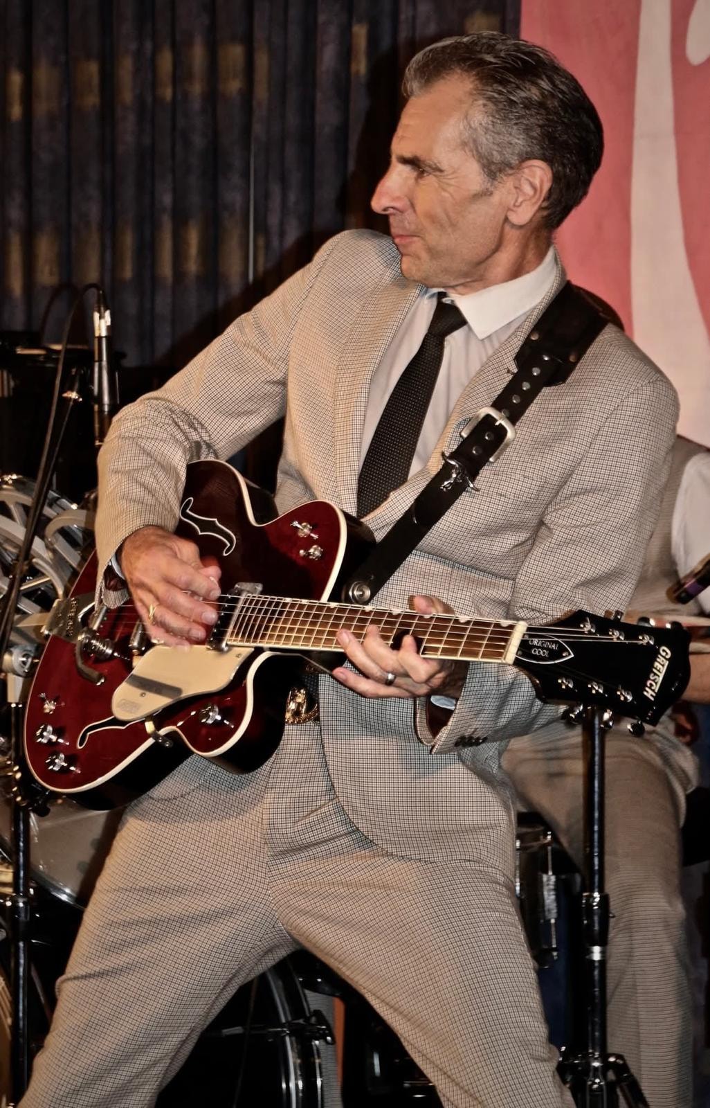 Guitarist close-up with Gretsch guitar on stage