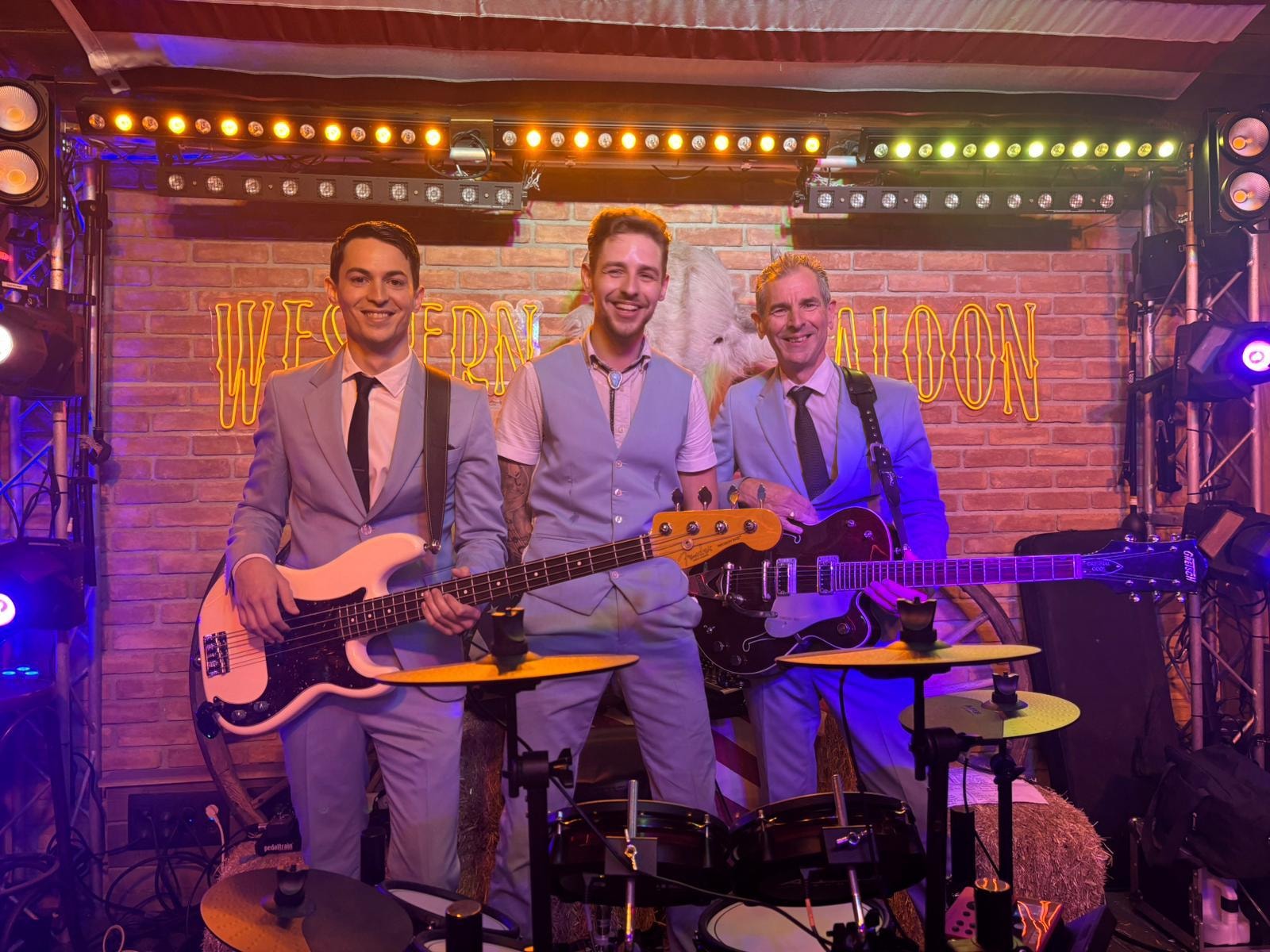 Full band at the Western Saloon — group shot with guitars