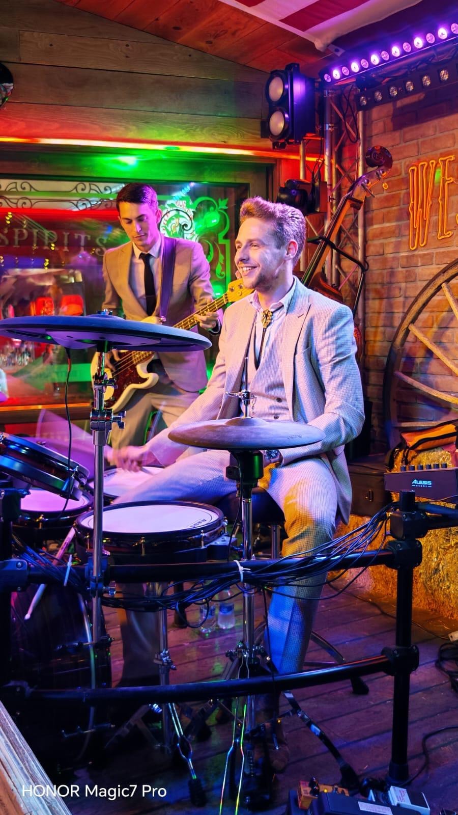 Musicians performing live in neon lit venue