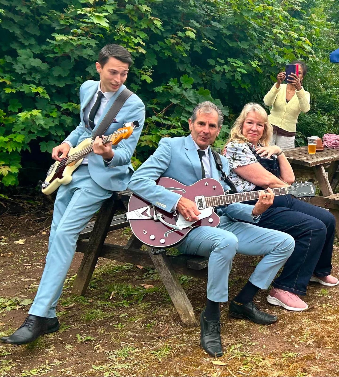 Guitarist and bassist on stage — outdoor festival